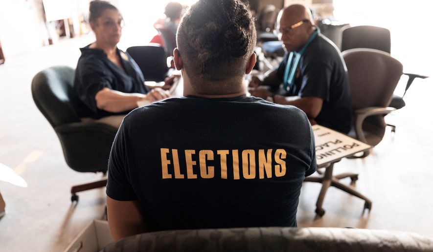 State election staff get voting machines ready on Thursday, May 14, 2026 for Saturday's election in New Orleans. /The Times-Picayune/The New Orleans Advocate via AP)