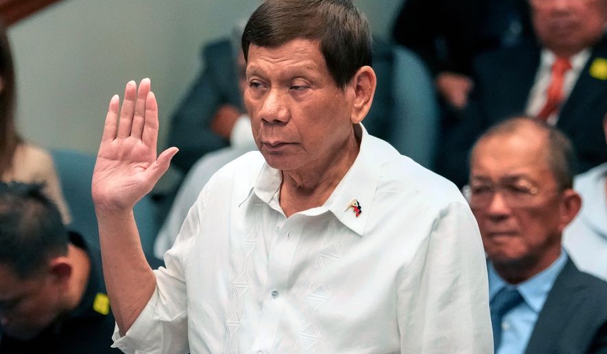 FILE - Former Philippine President Rodrigo Duterte takes oath during a senate inquiry on the so-called war on drugs during his administration at the Philippine Senate, on Oct. 28, 2024, in Manila, Philippines. (AP Photo/Aaron Favila, File)