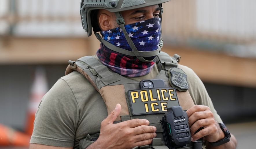 A masked ICE agent stands outside the Delaney Hall detention center during a protest against the transfer of detainees on Wednesday, May 27, 2026, in Newark, N.J. (AP Photo/Seth Wenig) ** FILE **