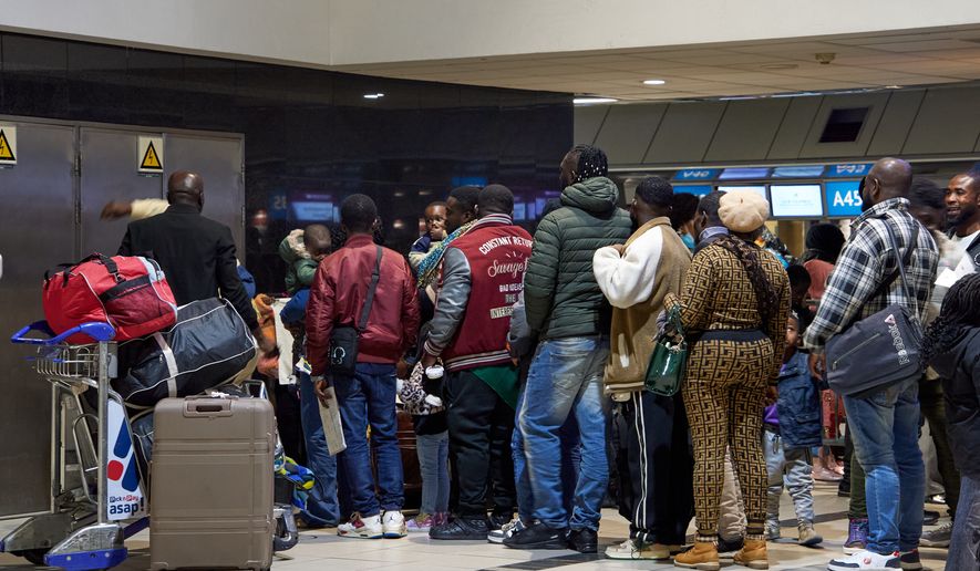 Ghanaian nationals queue with their luggage at O.R. Tambo International Airport as they prepare to board a repatriation flight home following unrest concerns in Johannesburg, South Africa, Wednesday, May 27, 2026. (AP Photo/Kayleen Morgan)