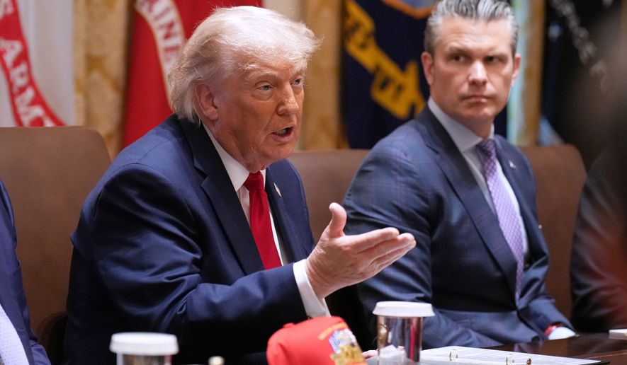 President Donald Trump speaks during a Cabinet meeting at the White House, Wednesday, May 27, 2026, in Washington, as Secretary of Defense Pete Hegseth, looks on. (AP Photo/Jacquelyn Martin)