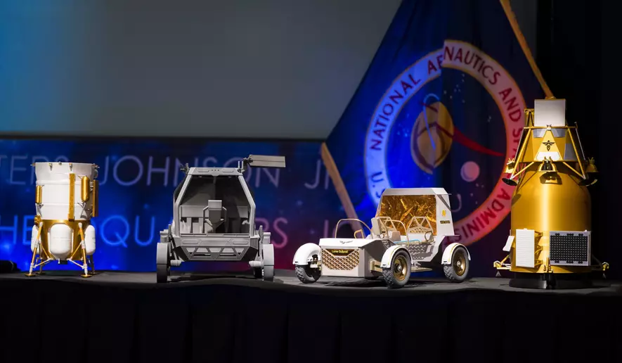 From left to right, models of the Blue Origin Mark 1 Lunar Lander, Astrolab Crewed Lunar Rover, Lunar Outpost Pegasus rover, and the Firely Elytra Dark orbiter are seen at the conclusion of a news conference to discuss Moon Base, a long-term lunar exploration and infrastructure initiative designed to enable sustained human presence and expanded scientific and commercial activity at the lunar South Pole, Tuesday, May 26, 2026, at the Mary W. Jackson NASA Headquarters building in Washington. (Photo and caption credit: NASA/Aubrey Gemignani)
