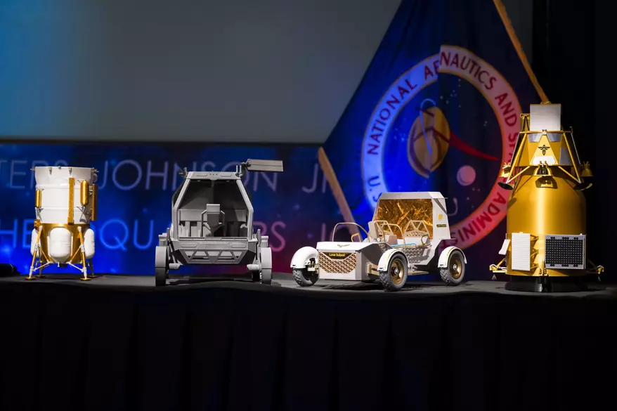 From left to right, models of the Blue Origin Mark 1 Lunar Lander, Astrolab Crewed Lunar Rover, Lunar Outpost Pegasus rover, and the Firely Elytra Dark orbiter are seen at the conclusion of a news conference to discuss Moon Base, a long-term lunar exploration and infrastructure initiative designed to enable sustained human presence and expanded scientific and commercial activity at the lunar South Pole, Tuesday, May 26, 2026, at the Mary W. Jackson NASA Headquarters building in Washington. (Photo and caption credit: NASA/Aubrey Gemignani)