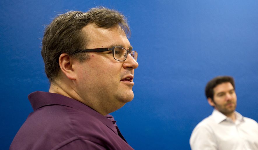 LinkedIn co-founder Reid Hoffman discusses the business networking site's performance on Tuesday, May 7, 2013, in Mountain View, Calif. Listening at right is CEO Jeff Weiner. (AP Photo/Noah Berger)
