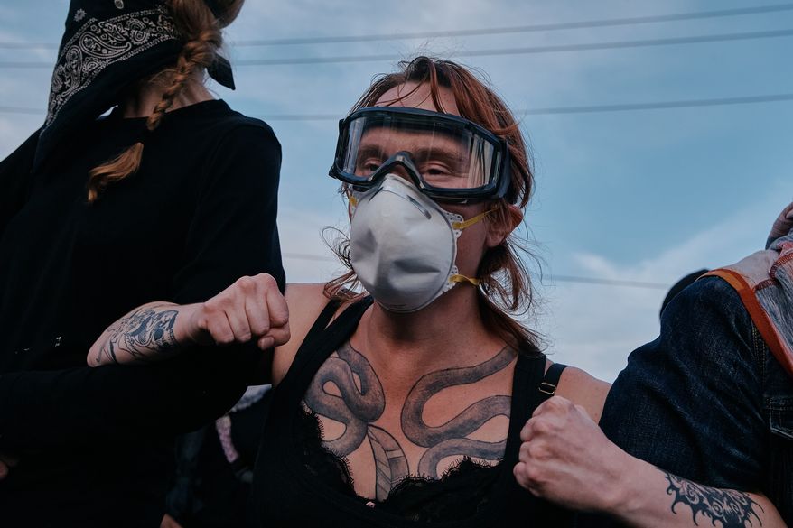 Protesters confront ICE agents outside the Delaney Hall detention center while demonstrating near the entrance gates, Wednesday, May 27, 2026, in Newark, N.J. (AP Photo/Andres Kudacki)