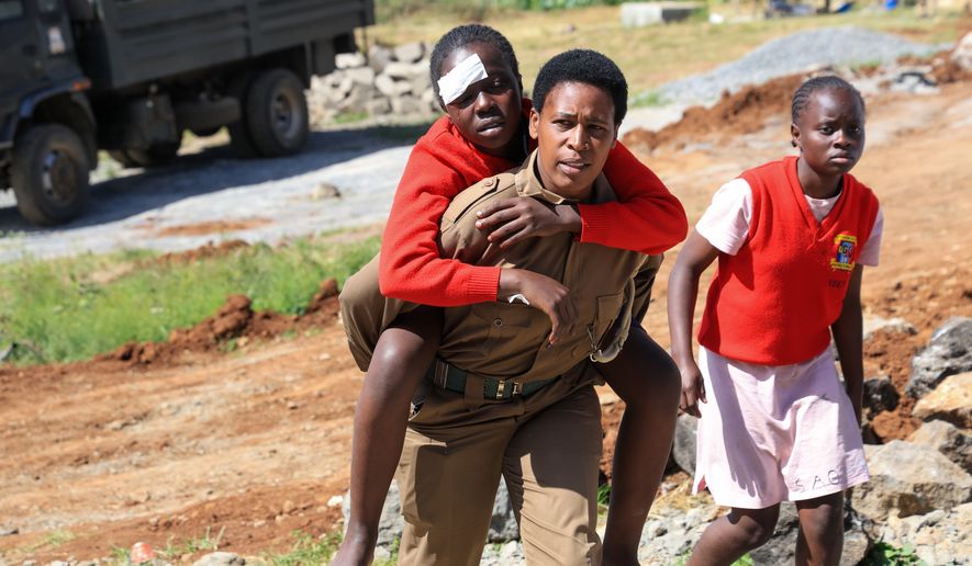 An injured student is evacuated following an early morning fire outbreak at Utumishi Girls School in the Gilgil area, central Kenya, Thursday, May 28, 2026. (AP Photo/Andrew Kasuku)