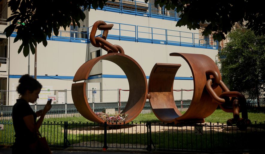 A statue named "Chains," by French artist Driss Sans-Arcidet, honoring the memory of the abolition of slavery, is photographed in a park in Paris, Wednesday, May 27, 2026, as France's National Assembly examines a bill to formally repeal the Code Noir, or Black Code, the 17th-century royal edict that governed slavery in French colonies and treated enslaved people as property. (AP Photo/Thomas Padilla)