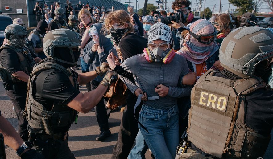 Protesters confront ICE agents outside the Delaney Hall detention center while demonstrating near the entrance gates, Wednesday, May 27, 2026, in Newark, N.J. (AP Photo/Andres Kudacki)