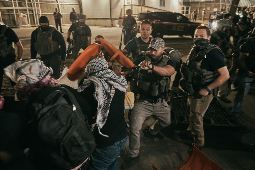 Protesters clash with ICE agents outside the Delaney Hall detention center while demonstrating near the entrance gates, Wednesday, May 27, 2026, in Newark, N.J. Inside the facility, detainees carried out a labor and hunger strike for days over alleged living conditions. (AP Photo/Andres Kudacki)