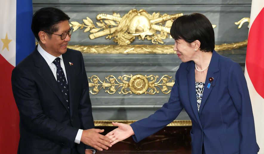 Japanese Prime Minister Sanae Takaichi, right, and Philippine President Ferdinand Marcos Jr., shake hands before a summit meeting at the Akasaka Palace state guest house in Tokyo, Japan, on Thursday, May 28, 2026. (Kiyoshi Ota/Pool Photo via AP)