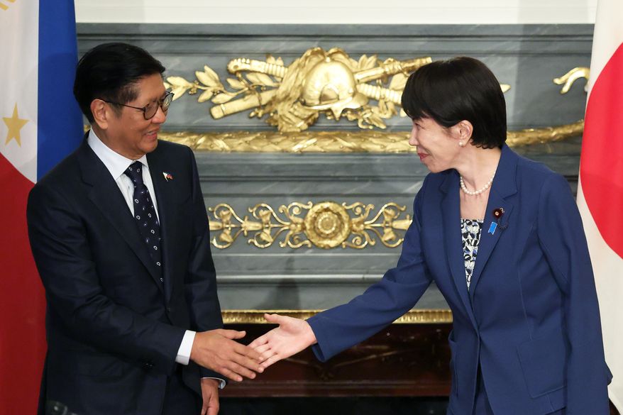Japanese Prime Minister Sanae Takaichi, right, and Philippine President Ferdinand Marcos Jr., shake hands before a summit meeting at the Akasaka Palace state guest house in Tokyo, Japan, on Thursday, May 28, 2026. (Kiyoshi Ota/Pool Photo via AP)