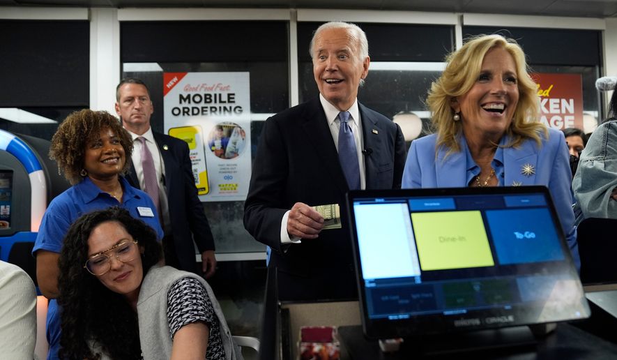 President Joe Biden, center, and first lady Jill Biden, right, pay for a purchase as they greet supporters at a Waffle House in Marietta, Ga., June 28, 2024, following a presidential debate in Atlanta. (AP Photo/Evan Vucci, File)