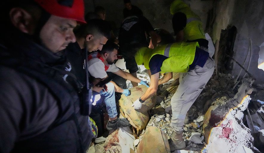 Rescue workers search for victims inside a destroyed apartment that was hit in an Israeli airstrike in the southern port city of Sidon, Lebanon, Thursday, May 28, 2026. (AP Photo/Mohammed Zaatari)