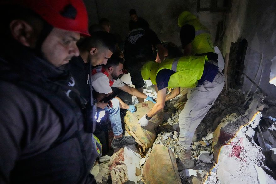 Rescue workers search for victims inside a destroyed apartment that was hit in an Israeli airstrike in the southern port city of Sidon, Lebanon, Thursday, May 28, 2026. (AP Photo/Mohammed Zaatari)