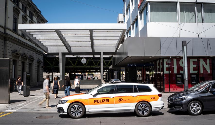 A police vehicle is parked in front of Winterthur train station following a stabbing attack in Winterthur, Switzerland, Thursday, May 28, 2026. (Claudio Thoma/Keystone via AP)