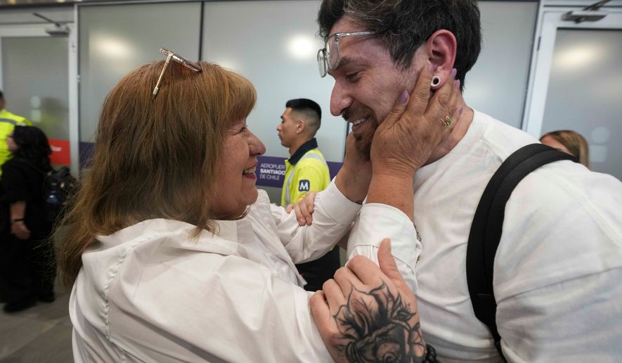Kyle Adler, a 36-year-old Chilean American who was taken from his family at nine months old and illegally adopted, embraces his birth mother, Ana Maria Navarrete, after traveling from the U.S. to meet her for the first time, in Santiago, Chile, Saturday, Feb. 14, 2026. (AP Photo/Esteban Felix)