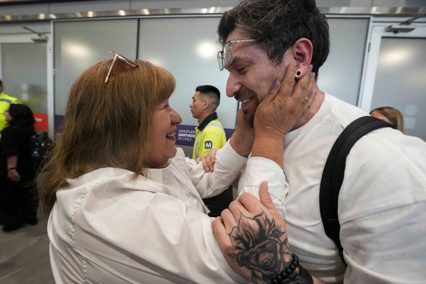 Kyle Adler, a 36-year-old Chilean American who was taken from his family at nine months old and illegally adopted, embraces his birth mother, Ana Maria Navarrete, after traveling from the U.S. to meet her for the first time, in Santiago, Chile, Saturday, Feb. 14, 2026. (AP Photo/Esteban Felix)