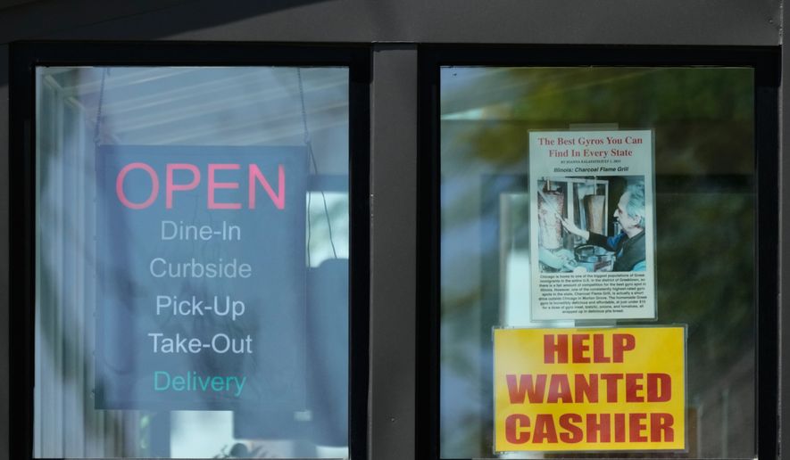A hiring sign is displayed at a restaurant in Morton Grove, Ill., Thursday, May 14, 2026. (AP Photo/Nam Y. Huh)