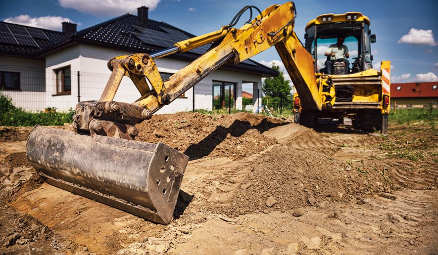Excavator working at house construction site. File photo credit: Wstockstudio via Shutterstock.