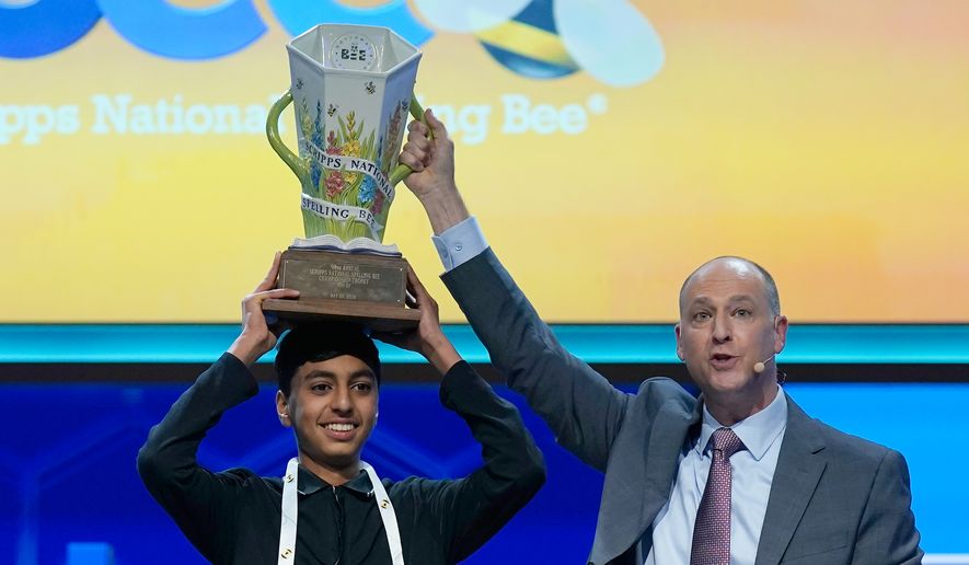 E.W. Scripps Company president and CEO Adam Symson, right, holds the trophy over winner of the 2026 Scripps National Spelling Bee, Shrey Parikh, 14, of Rancho Cucamonga, Calif., at DAR Constitution Hall, Thursday, May 28, 2026, in Washington. (AP Photo/Jose Luis Magana)