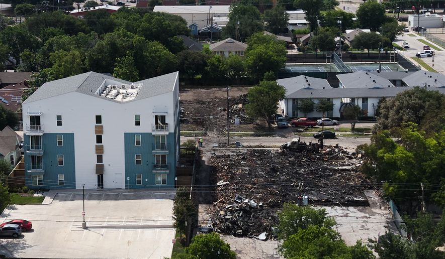 Damage is visible following an apartment complex fire, Friday, May 29, 2026, in Dallas. (AP Photo/Julio Cortez)