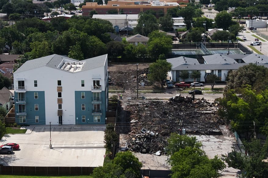 Damage is visible following an apartment complex fire, Friday, May 29, 2026, in Dallas. (AP Photo/Julio Cortez)