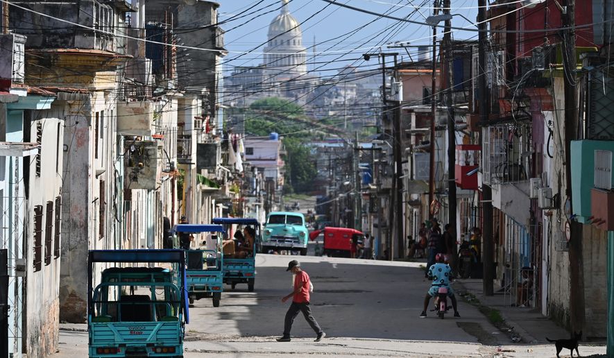 A man crosses a street in Havana, Monday, May 25, 2026. (AP Photo/Jorge Luis Banos)