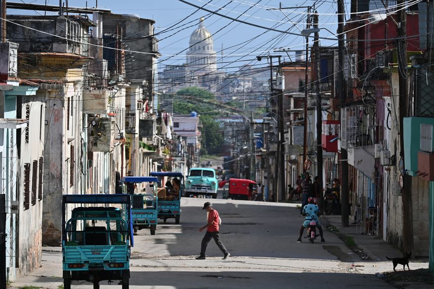A man crosses a street in Havana, Monday, May 25, 2026. (AP Photo/Jorge Luis Banos)