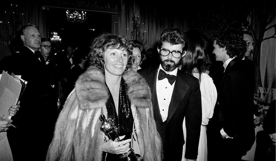 FILE - Marcia Lucas, wife of director George Lucas, right, carries her Oscar statuette as they arrive at a post Academy Awards party at the Beverly Hilton Hotel in Los Angeles, April 4, 1978. (AP Photo, File)