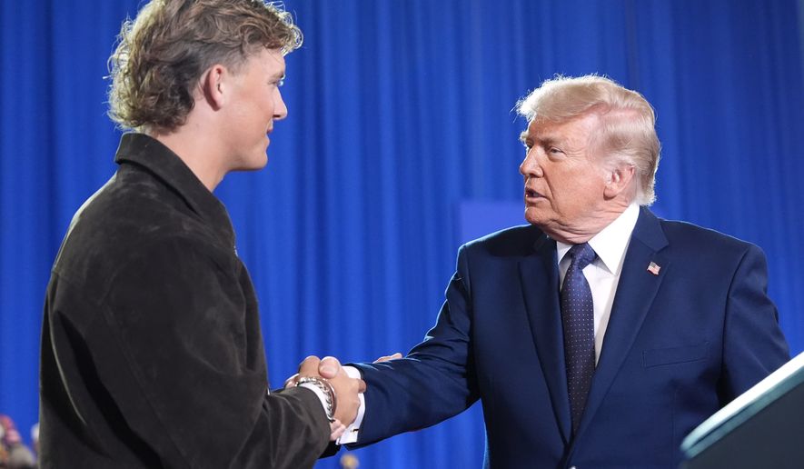 President Donald Trump shakes hands with New York Giants quarterback Jaxson Dart as he arrives to speak at Rockland Community College, Friday, May 22, 2026, in Suffern, N.Y. (AP Photo/Alex Brandon)