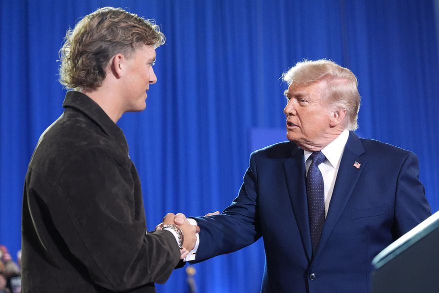President Donald Trump shakes hands with New York Giants quarterback Jaxson Dart as he arrives to speak at Rockland Community College, Friday, May 22, 2026, in Suffern, N.Y. (AP Photo/Alex Brandon)
