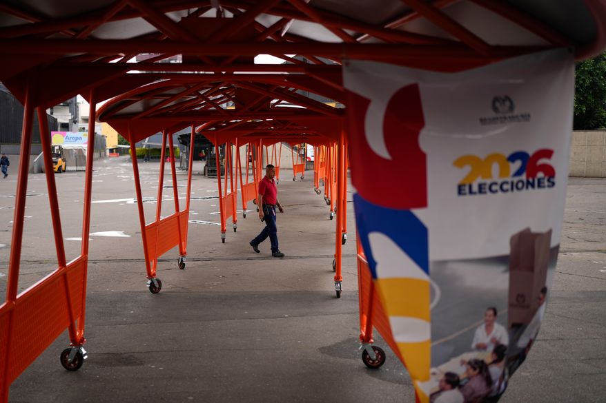 A man walks through a voting center in preparation for Sunday's presidential election in Bogota, Colombia, Friday, May 29, 2026. (AP Photo/Matias Delacroix)