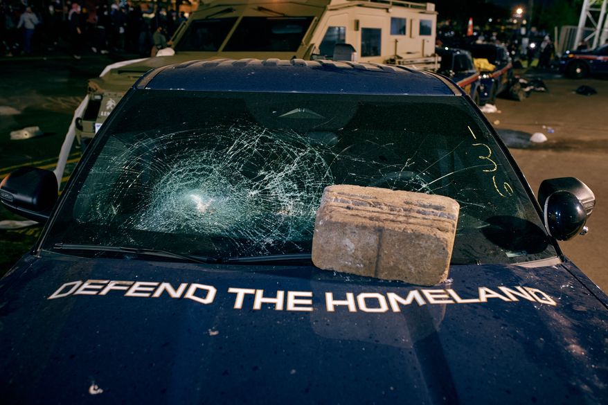 A brick sits on the hood of a damaged Department of Homeland Security vehicle outside the Delaney Hall detention center following a protest Friday, May 29, 2026, in Newark, N.J. (AP Photo/Andres Kudacki)