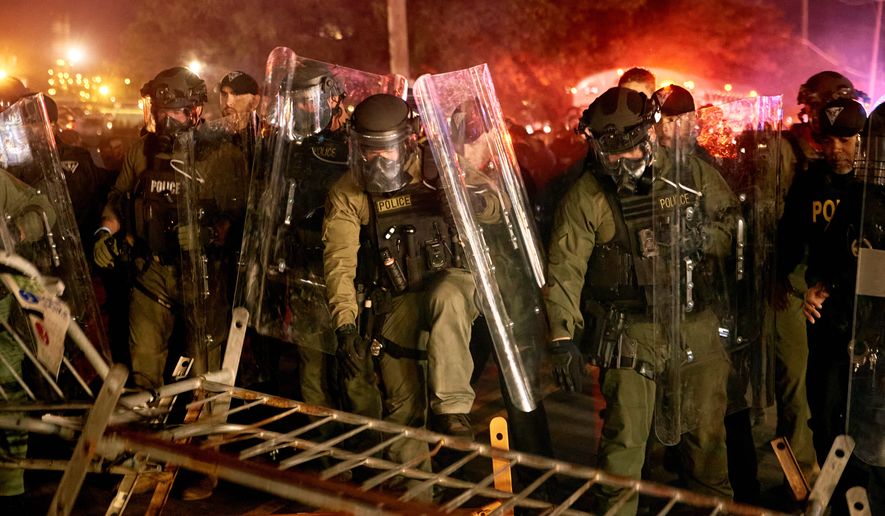 Police pass over a barricade as they clash with protesters near the Delaney Hall detention center during a protest against the transfer of detainees and federal immigration policies on Saturday, May 30, 2026, in Newark, N.J. (AP Photo/Andres Kudacki)