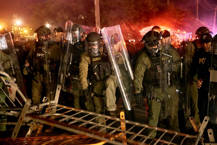 Police pass over a barricade as they clash with protesters near the Delaney Hall detention center during a protest against the transfer of detainees and federal immigration policies on Saturday, May 30, 2026, in Newark, N.J. (AP Photo/Andres Kudacki)