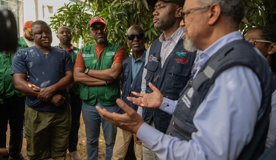Director General of the World Health Organisation (WHO), Tedros Adhanom Ghebreyesus, meets with health workers who recovered from Ebola in Bunia, Congo, Sunday, May 31, 2026. (AP Photo/Moses Sawasawa)