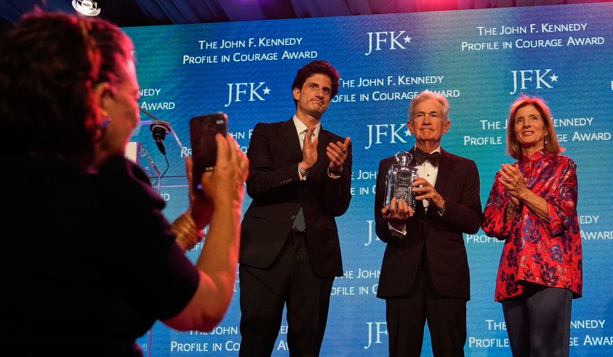 Federal Reserve Board Governor Jerome Powell, the former Federal Reserve chair, center, stands with former Ambassador Caroline Kennedy, right, and her son Jack Schlossberg, as Powell's wife Elissa Leonard takes a picture at left, while being honored with the Profile in Courage Award at the John F. Kennedy Presidential Library, Sunday, May 31, 2026, in Boston. (AP Photo/Charles Krupa)