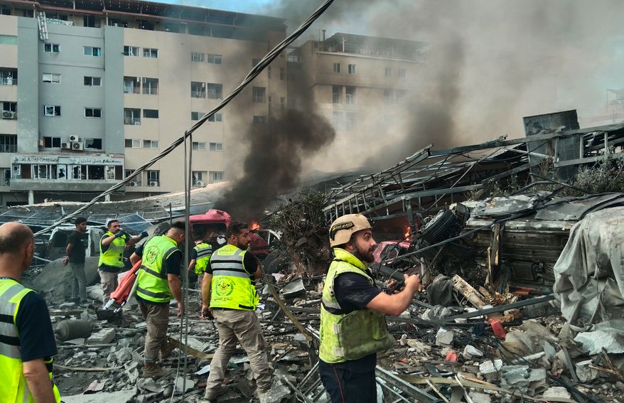 Rescuers work at the site of an Israeli airstrike that hit a building and damaged a hospital, seen in the background, in the southern port city of Tyre, Lebanon, Monday, June 1, 2026. (AP Photo)
