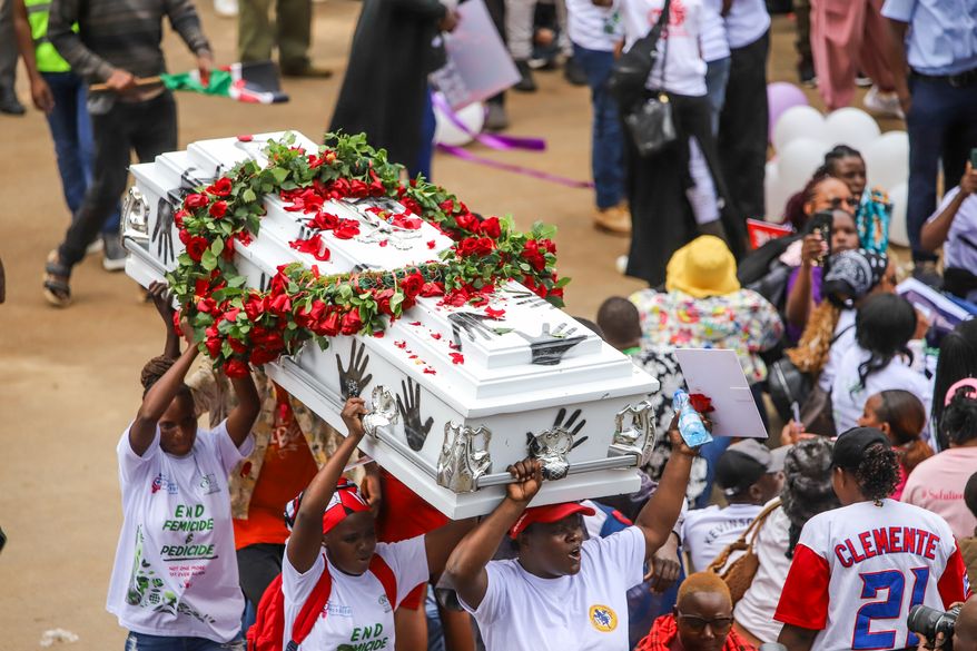 Demonstrators carry a coffin, during a march against rising cases of femicide, in downtown Nairobi, Kenya, Monday, June 1, 2026. (AP Photo/Patrick Ngugi)