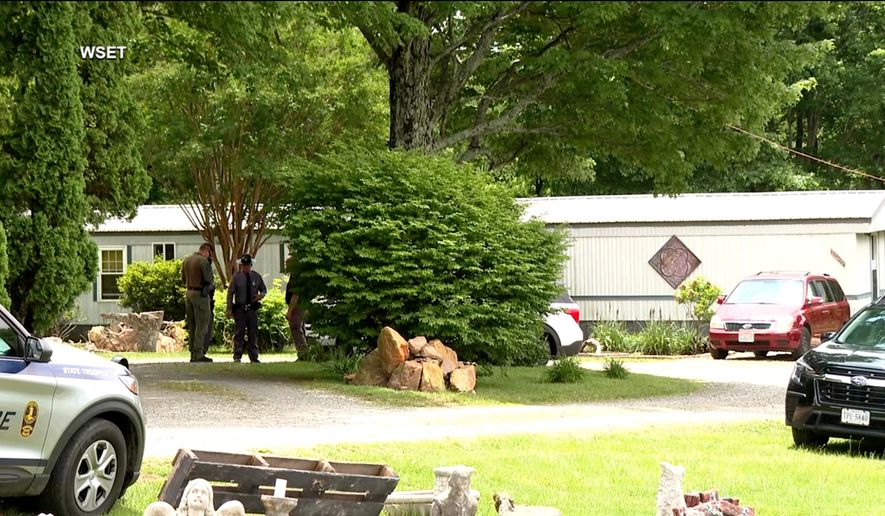 This image taken from video shows law enforcement at the scene of Michael Puckett's home in Carroll County, Va., on Saturday, May 30, 2026. (WSET via AP)