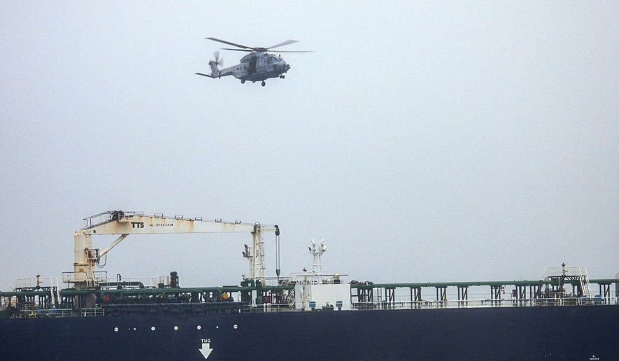 In this handout photo provided by the French Army, an NH90 helicopter intercepts an oil tanker that was traveling from Russia under international sanctions, on the Atlantic Sea, Sunday, May 31, 2026. (French Army via AP)