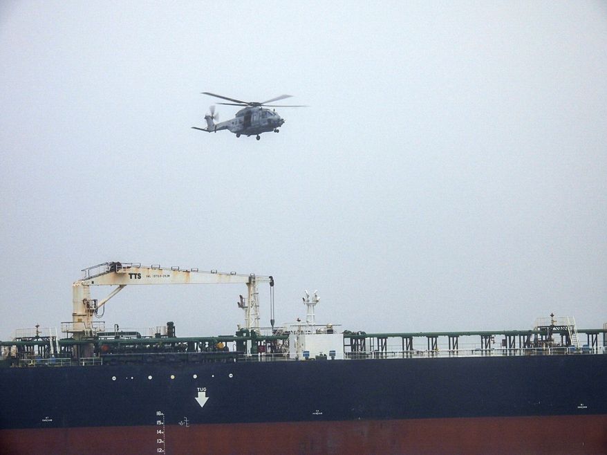 In this handout photo provided by the French Army, an NH90 helicopter intercepts an oil tanker that was traveling from Russia under international sanctions, on the Atlantic Sea, Sunday, May 31, 2026. (French Army via AP)