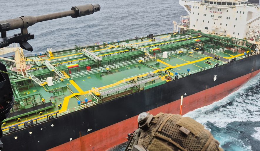 In this handout photo provided by the French Army, a French army NH90 helicopter flies over the oil tanker Tagor, which is under international sanctions and was traveling from Russia in the Atlantic Sea, Sunday, May 31, 2026. (French Army via AP)