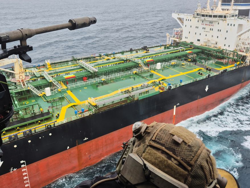 In this handout photo provided by the French Army, a French army NH90 helicopter flies over the oil tanker Tagor, which is under international sanctions and was traveling from Russia in the Atlantic Sea, Sunday, May 31, 2026. (French Army via AP)