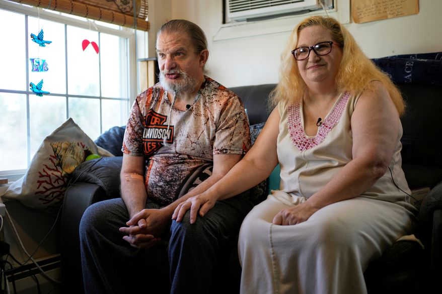 Brian and Brenda Marquis talk about a robot that helps them stay on task with everything from daily exercise to medication reminders at their apartment Tuesday, April 21, 2026, in Durham, N.H. (AP Photo/Robert F. Bukaty)