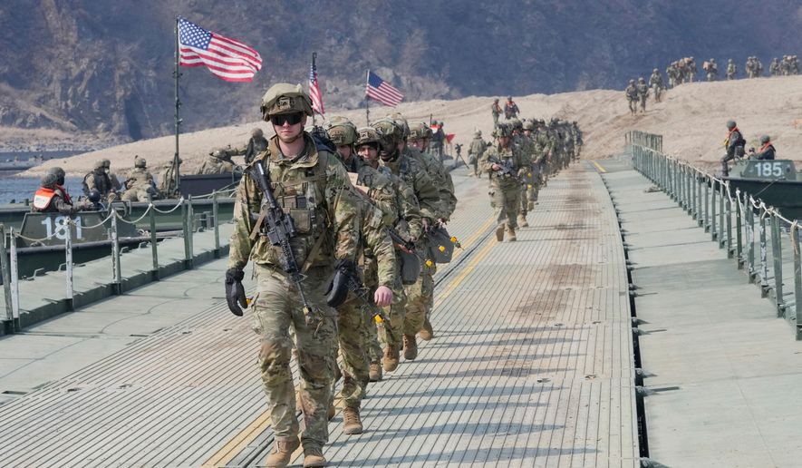 U.S. Army soldiers cross a floating bridge on the Imjin River during a joint river-crossing exercise between South Korea and the United States as a part of the Freedom Shield military exercise in Yeoncheon, South Korea, March 20, 2025. (AP Photo/Ahn Young-joon, File)