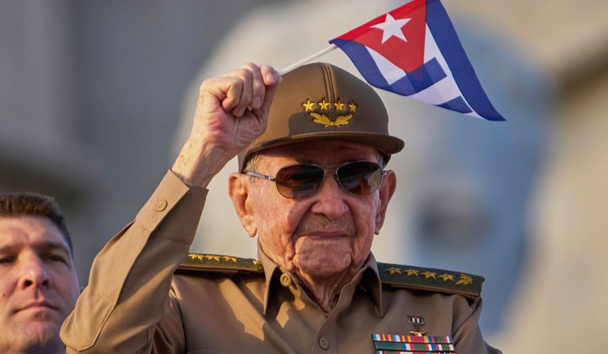 FILE - Raul Castro waves a Cuban national flag during a May Day parade at Revolution Square in Havana, May 1, 2025. (AP Photo/Ramon Espinosa, File)