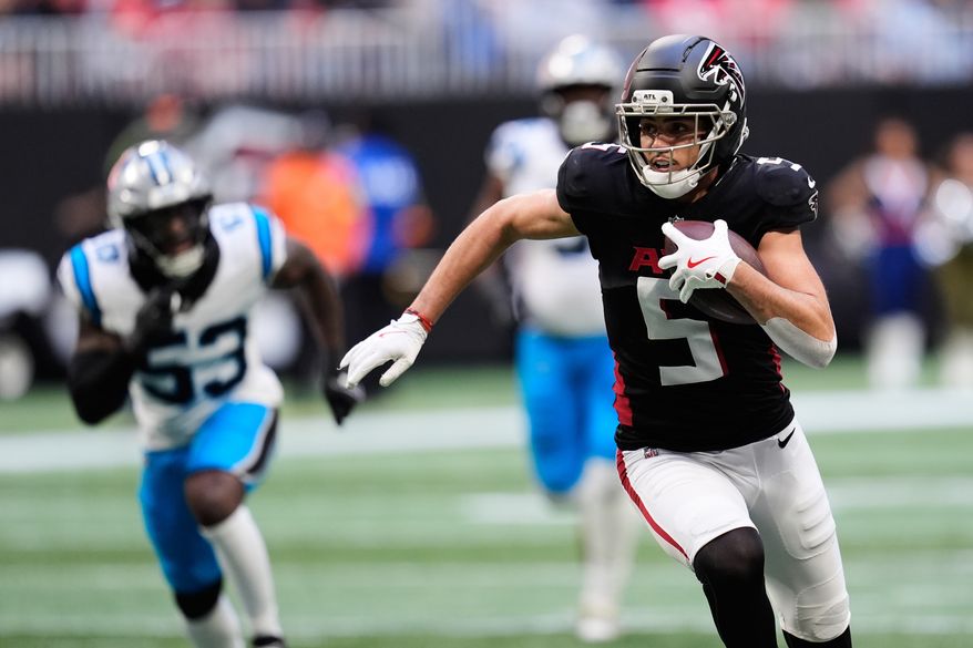 FILE - Atlanta Falcons wide receiver Drake London (5) carries against the Carolina Panthers in the first half of an NFL football game, Nov. 16, 2025, in Atlanta. (AP Photo/Mike Stewart, File)