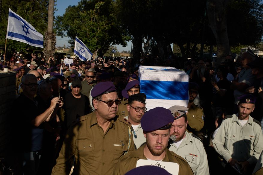 Israeli soldiers carry the coffin of Staff-Sergeant Michael Tyukin, who was killed in a drone attack in southern Lebanon, during his funeral in Ashkelon, Israel, Monday, June 1, 2026. (AP Photo/Leo Correa)