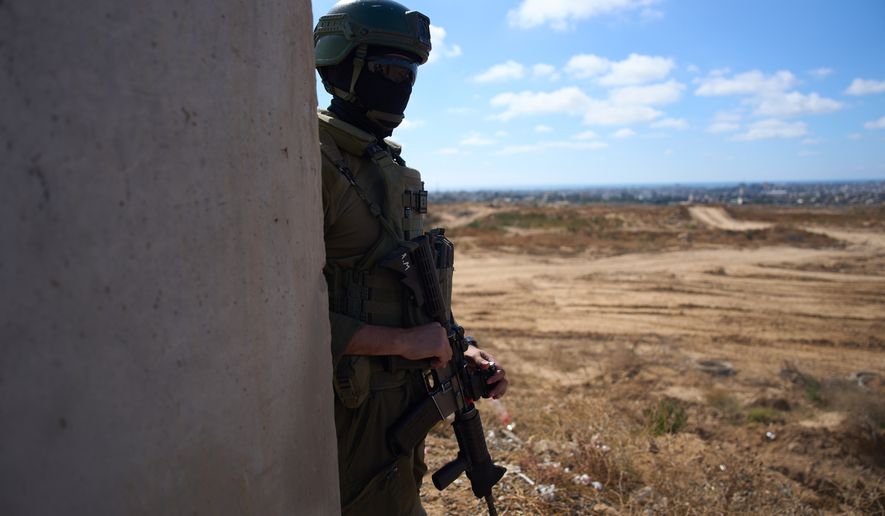 An Israeli soldier occupies a military position overlooking the so-called Yellow Line in the central Gaza Strip, Tuesday, May 26, 2026. (AP Photo/Ariel Schalit)